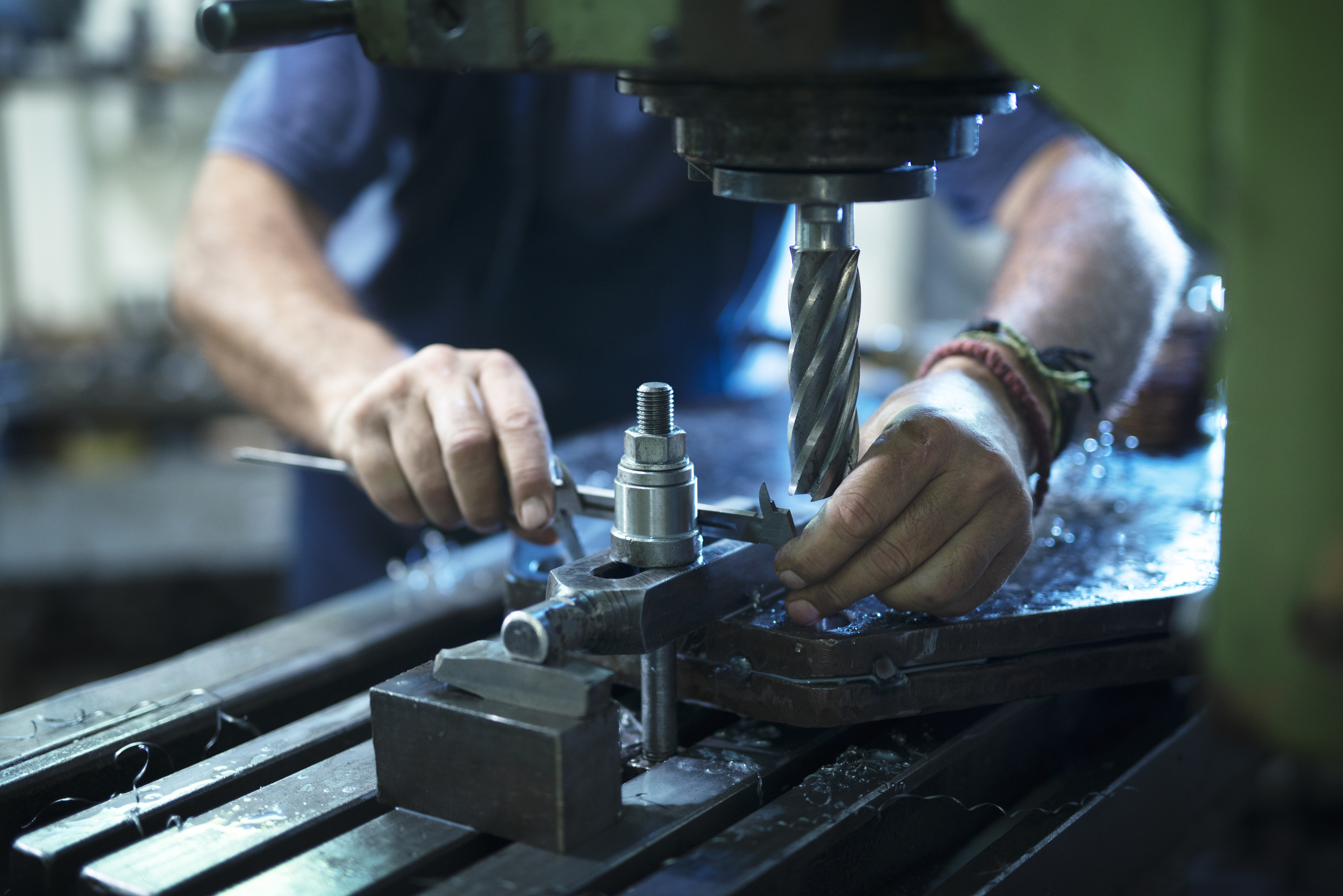 Workers building strapping machine in workshop.
